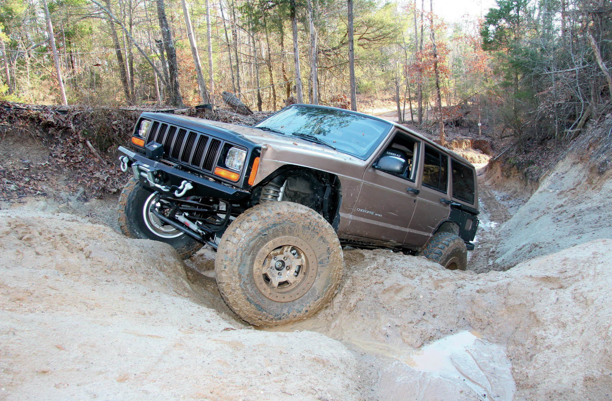 Our XJ’s rockers were rusted and dented from the previous owner. We’d planned on cutting them out and welding in custom high-clearance rocker guards, but we were anxious to hit the trail to get some other testing underway. The result was an even more crunched set of rockers by the end of the weekend! Maybe boat siding is in our future.