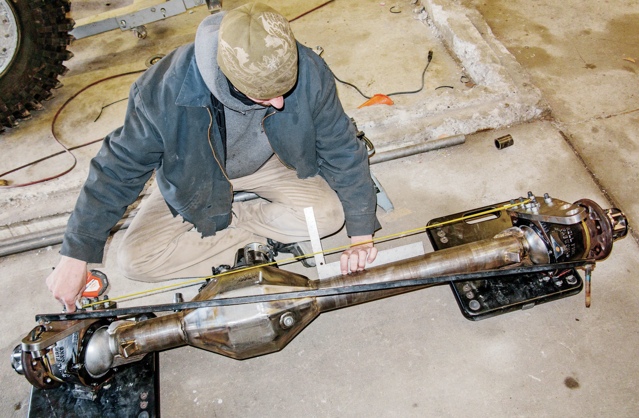 Jesse Haines measured the centerline of the axle to make certain that it was centered under the chassis. Mounting the lower links to the axle means finding a balance between fitment on the axlehousing and a separation wide enough for stability yet compact enough to allow the tire to turn to full lock without contacting the link.