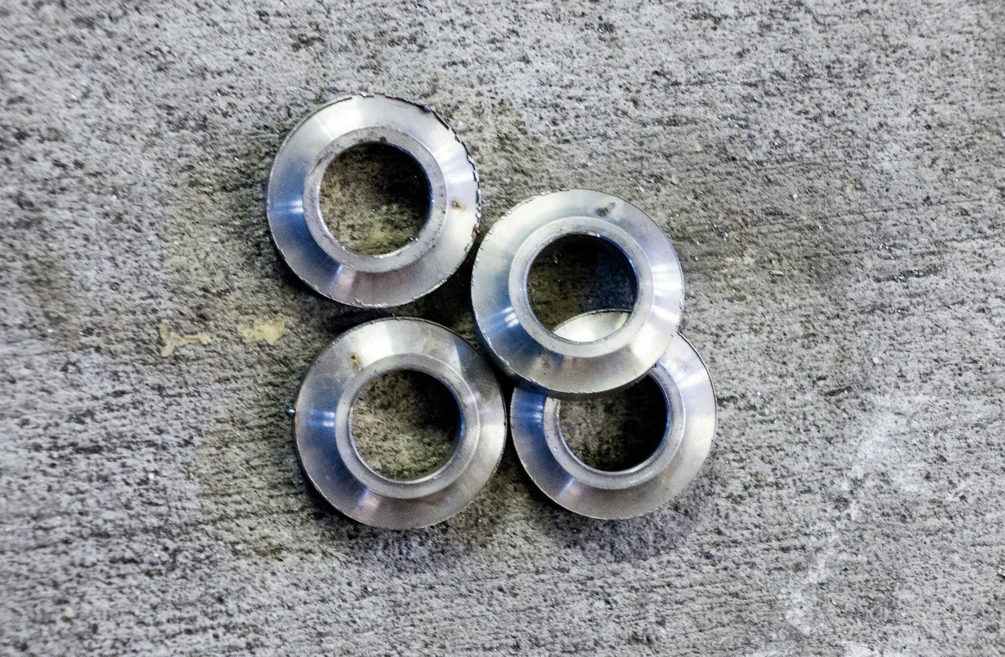 Weld washers don’t offer as much angularity as misalignment spacers, but they also do not require a smaller fastener to be used. Haines recommended running weld washers on all the control arm brackets to add a small degree of angularity. The larger benefit though is the ability to build thinner, and thus lighter, brackets without concern of the holes becoming egg-shaped after hard use off-road.