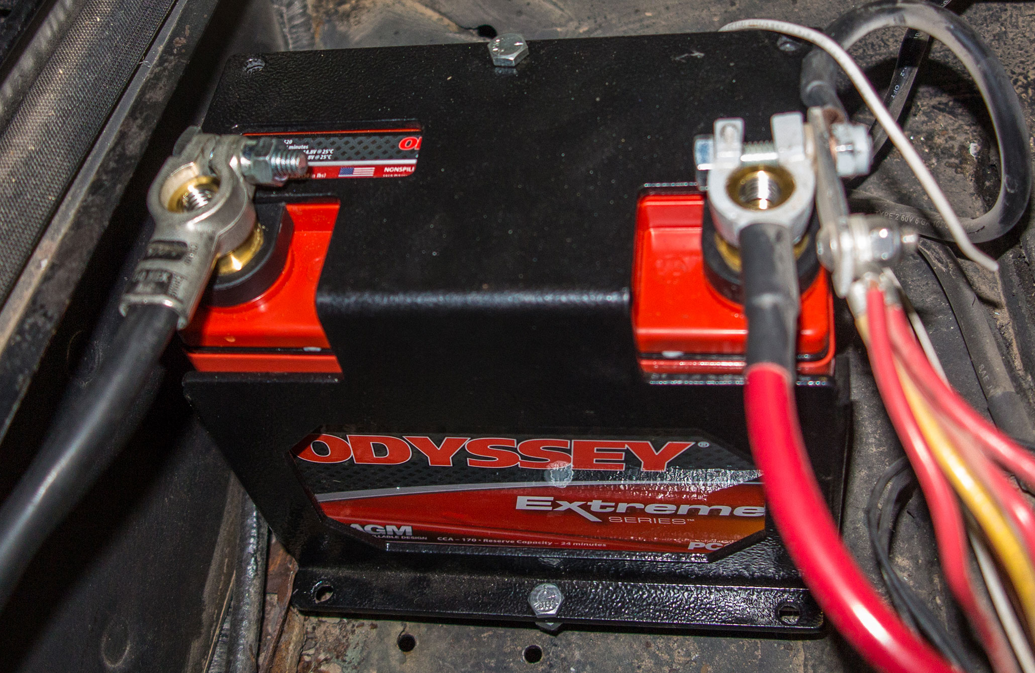 Artec Industries makes battery boxes that fit a variety of Odyssey, Optima, and Die Hard batteries. This bracket allowed us to mount a compact Odyssey PC680 behind the driver seat, where it is easy to access.