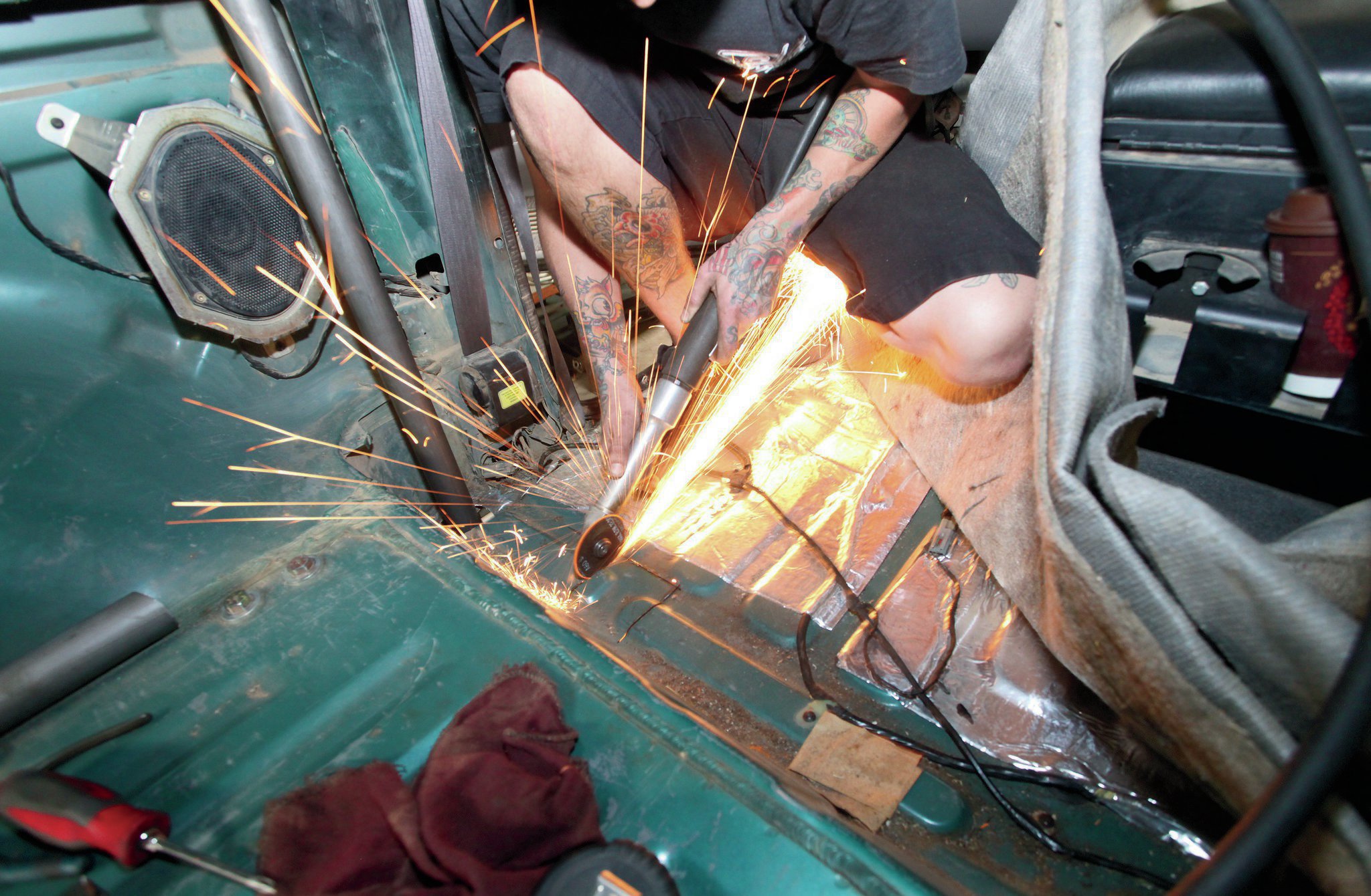 Another set of holes are cut into the floorpan, this time for the struts just aft of the front seats. These were left till after most of the ’cage was in to determine proper location in regards to the rear seats.