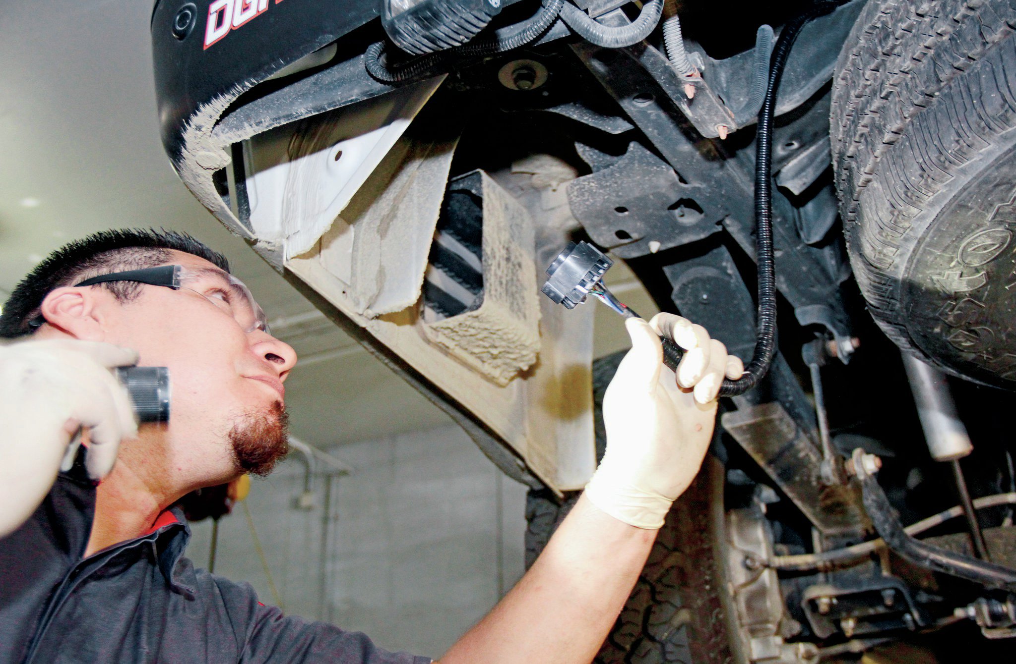 Once the harness is properly connected, run it to the back of the vehicle where the hitch will be installed.
