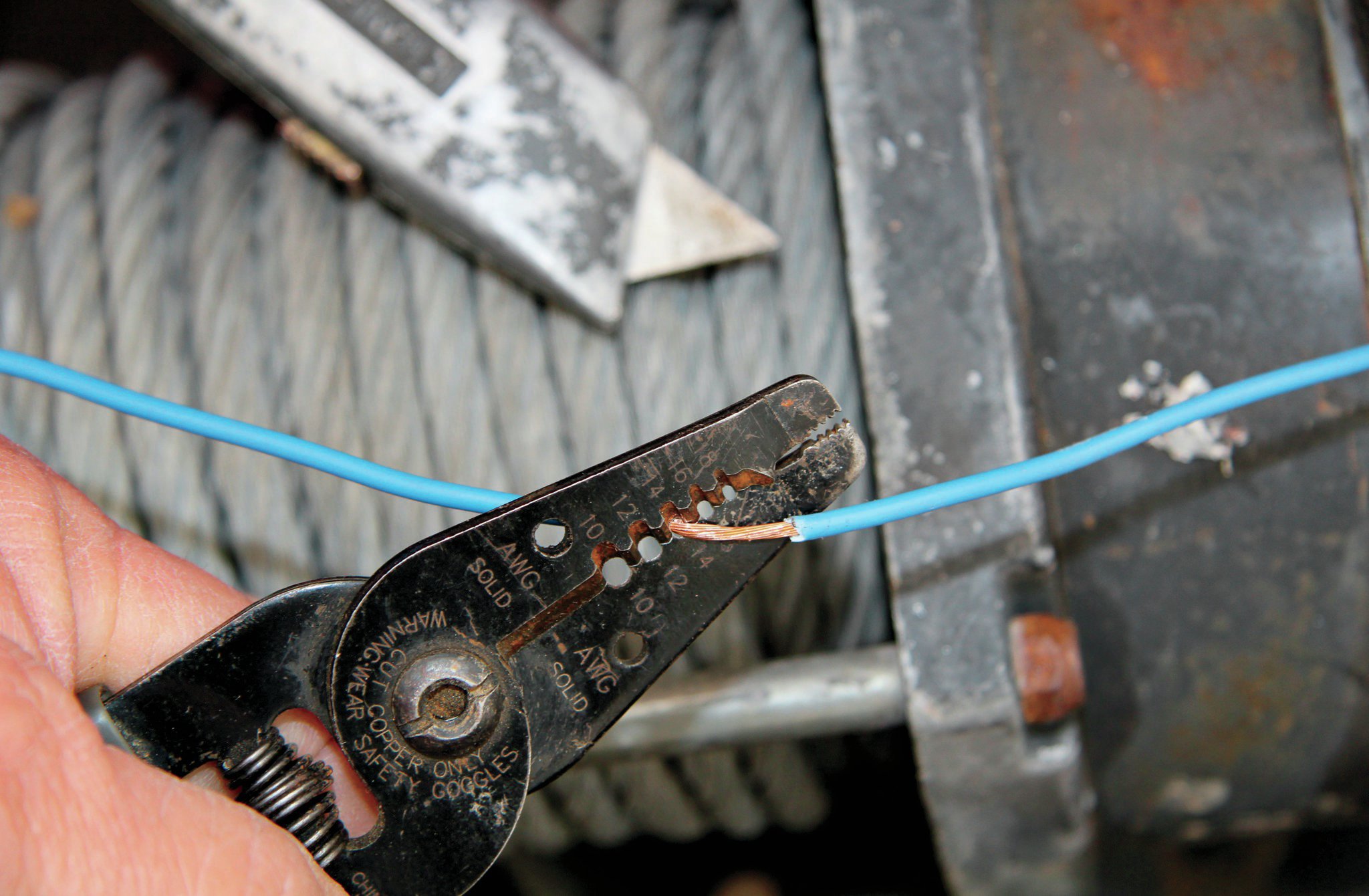 Look, I know it’s a pain in the butt, but if you are going to tap into a wire, this is the right way to do it. Don’t use a Scotch-lock. Use a quality wire stripper and cut the insulation—and only the insulation—about an inch back on the wire. See the cuts? Then use a utility knife to cut the inch of insulation away. Be careful to not cut the original wire with the either the knife or the strippers.