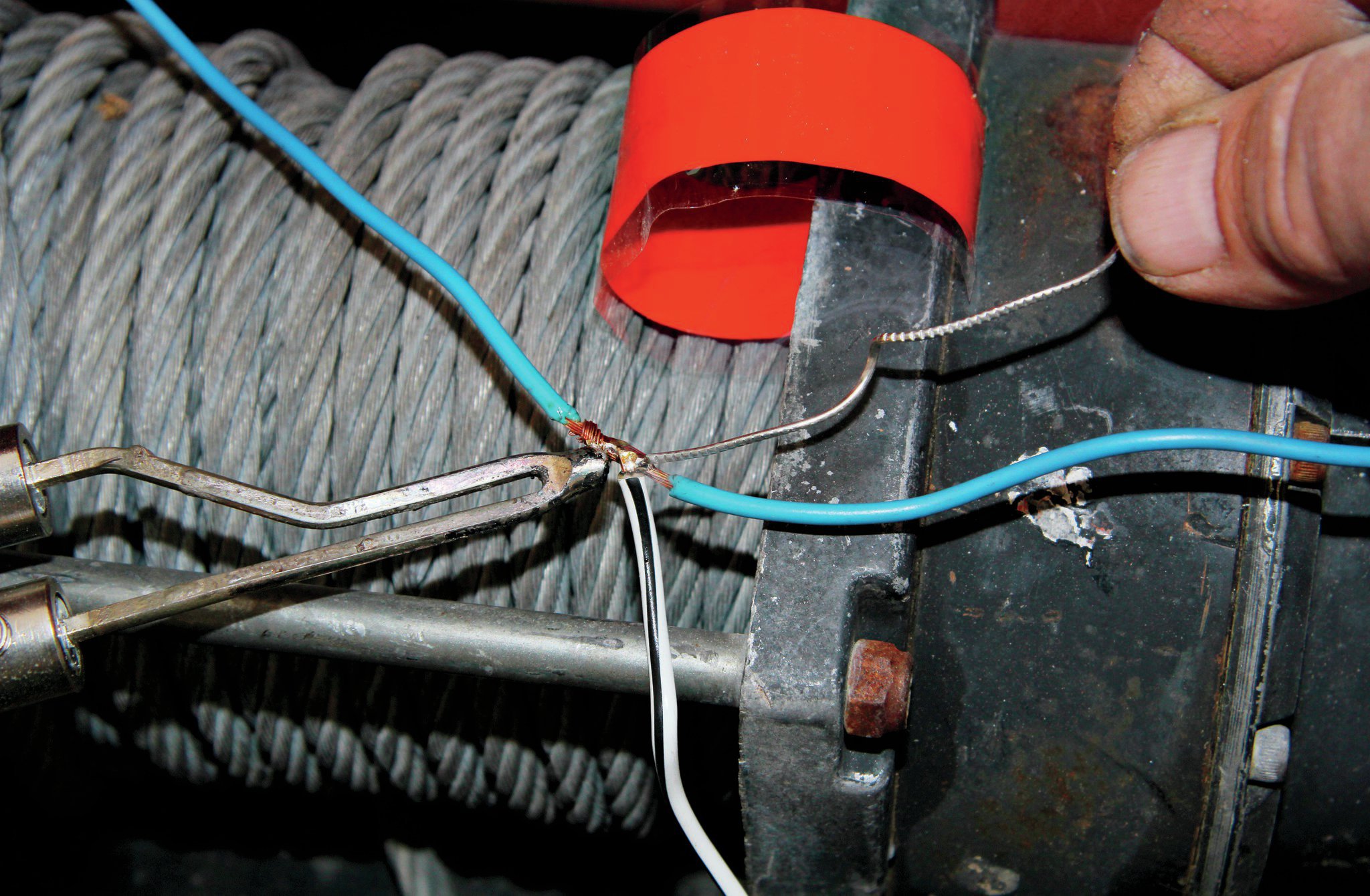 After that, take out your trusty soldering iron I showed you guys how to use, like, 1,000 years ago. Wrap the new wire around the exposed section of old wire and solder it in. I usually wrap it with just electrical tape because I am cheap. However, some self-curing silicone tape, such as Rescue Tape (rescuetape.com) makes for a better and more weather tight seal. The problem is you can’t use marine heat shrink and if you cut the original wire, the connection is more likely to fail with the vibrations your Jeep sees.