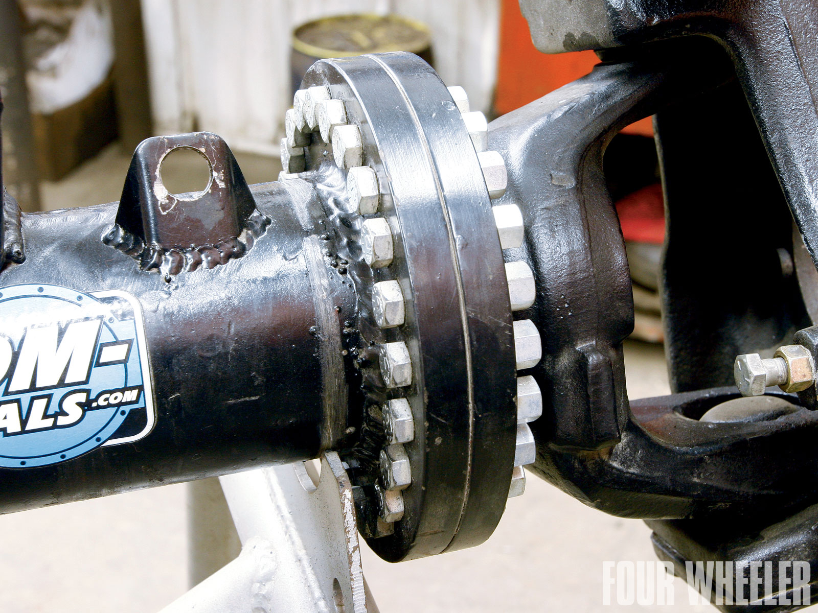 In addition to a slew of rear Dana 80s, Custom Diff says that they've built several of these custom front Dana 80s over the years. This specific axle was made from a Dodge dual rear wheel application. It can be used either in the front of a vehicle or in the rear where rear steer is desired. They were able to machine the factory axletubes to accept Chevy Dana 60 outers. This specific axle is unique in that it has adjustable knuckles. Custom Diff installed adjustable flanges (pressed and then welded) that allow the knuckles to be rotated to compensate for changes in pinion angle. This means the alignment of the axle remains intact, no matter how much the axle is rotated.