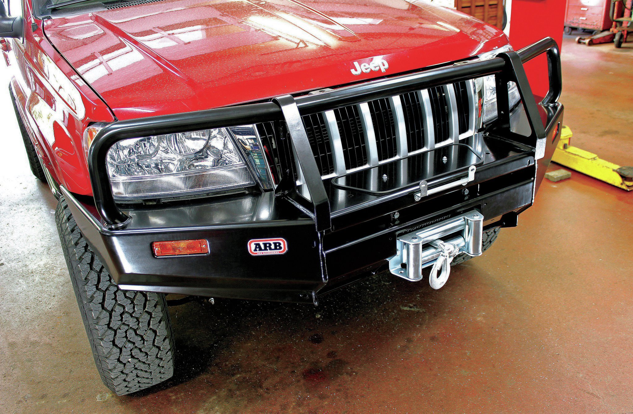 The Bull Bar’s stout construction gives simplistic lines, a pretty decent approach angle, and importantly, doesn’t peg the pork-o-meter in the weight department. Unlike most aftermarket WJ winch bumpers, an integral grilleguard is standard equipment. We bolted the winch to the bumper prior to installation, and other than having to re-index the gearbox in order to reach the winch’s engagement lever and mount the winch’s solenoid box remotely to clear the front frame crossmember, we hoisted the combination into place with zero drama.