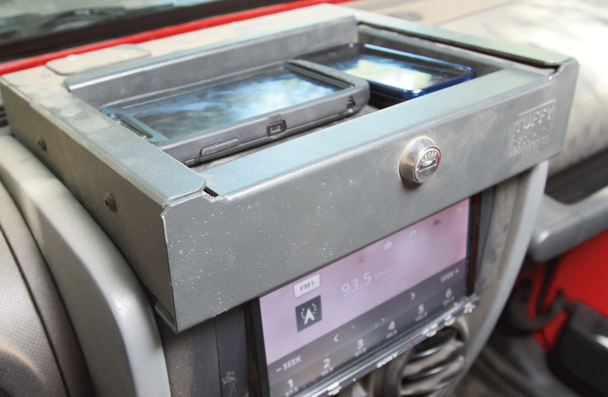 In the open position, the Flip-N-Lock allows plenty of access to the head unit, and provides a great place to drop cell phones. However, in some lighting conditions, we’ve had the phones get hot and shut down because of the sun coming through the windshield. However, the same can be said of any tray placed up there.