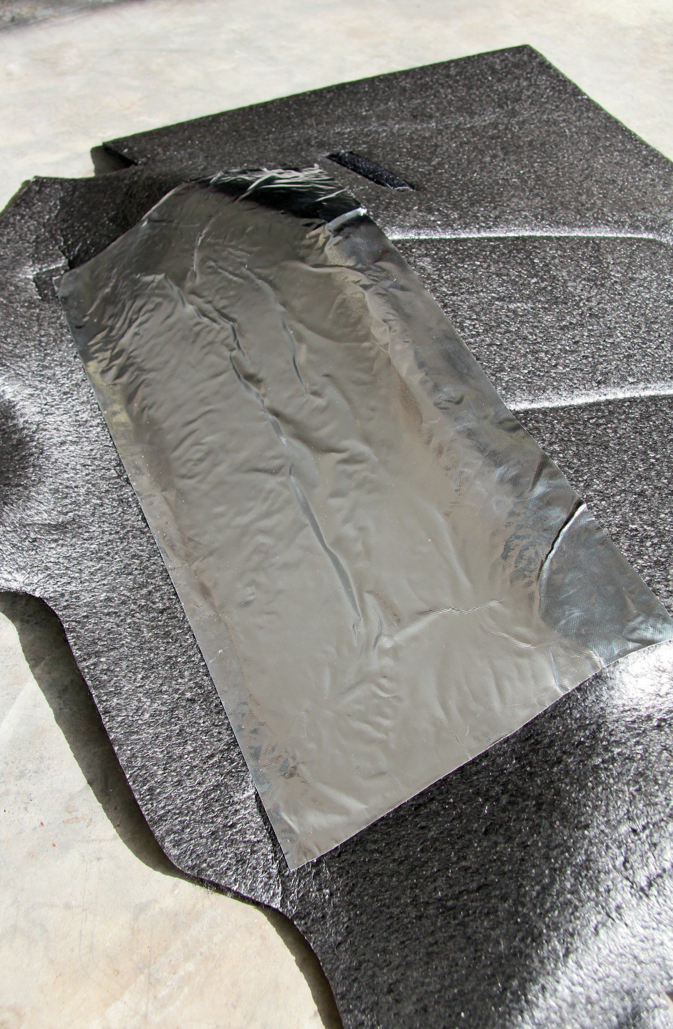 To combat heat radiating from the transmission tunnel, BedRug supplies adhesive-backed heat shields. In combination with the 1⁄4-inch-thick material, it helps insulate the radiant heat very well.