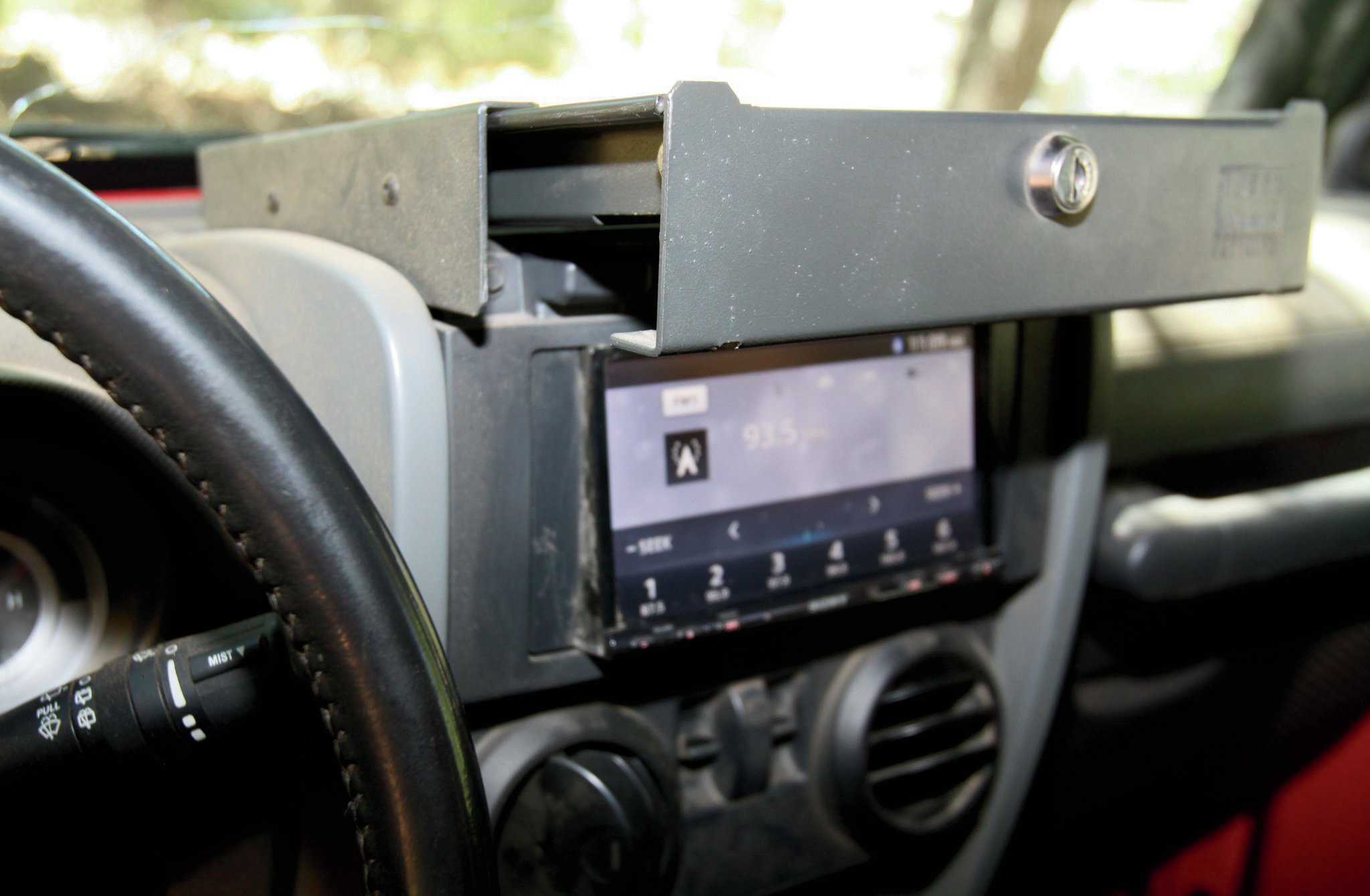 One thing to bear in mind: If you do end up gifting this to your Jeeper, warn him or her to lock the cover, whether it’s open or closed. We left it unlocked one day when we hit trails and ended up with the cover and our cell phones all over the Jeep. It slid right out the first little washboard we hit and various things landed in our laps—and that is with having it adjusted a little bit snug to make sure it won’t rattle. Some people have problems understanding just how it works until we show them this.