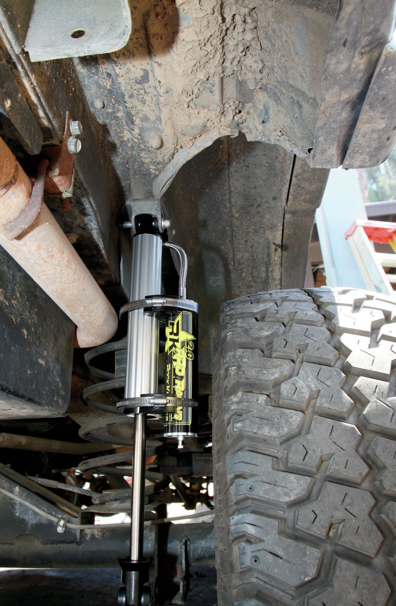 Like we said, it is a unique setup with the rear coil conversion. Rock Krawler had never built shocks for this application before, and as-delivered, the reservoirs were just too close to the tire for our liking. However, the Jeeps R Us crew figured it out in short order. The way the top bushing and reservoir line are oriented, by switching the shocks from side to side and then rotating the reservoirs so they sat behind the shocks, it all fit great. We’ve been in contact with Rock Krawler, and they know what we did, so future shocks coming out of the shop will already be set right for this application.
