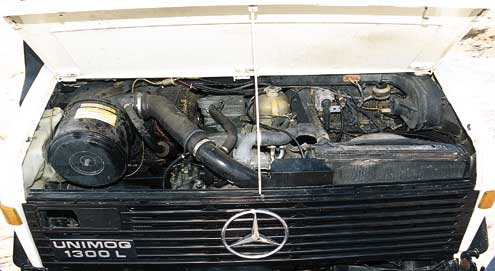 NThe engine is a turbocharged Mercedes six, good for about 170 hp at 2,800 rpm. The canister on the left is a centrifugal-type air cleaner, extremely helpful in separating water from incoming air.