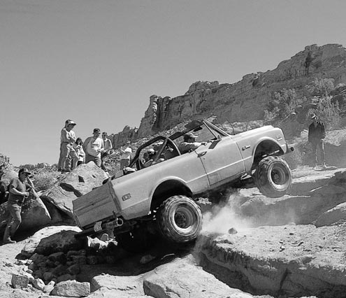 Here’s an example of high gears, high power, and not much success. The stock 3.08 gears and tall tires on this Blazer require a momentum approach to the obstacle, where as lower gears and a lighter foot would help. Sometimes a blip of the throttle can ease you over a ledge, but slow and steady crawling from low gears makes it easy.