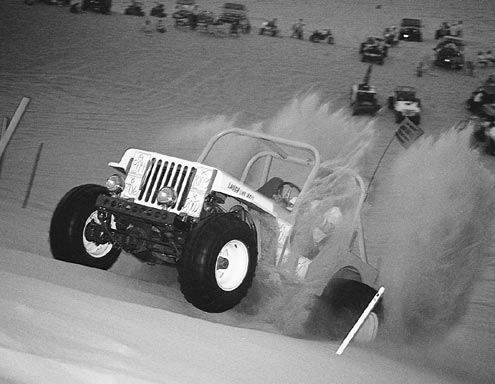 Sand is a whole other ball game. Wheelspin is needed to keep your tires floating across the surface. Lower gears are also needed to keep the engine in its powerband, but too low a gear will cause the engine to wind out before the wheels can get up to the speed they need to be.