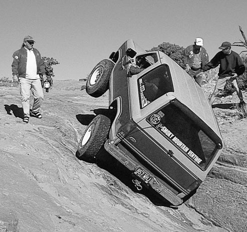 Slow and controlled is what this Bronco II is doing. Too much power and he’d be on his back. Rockcrawling and other trail sports dictate a certain finesse, which can be done with massive motors, but it’s easier with lower gears. Big-blocks can help with the steady amount of torque at most engine speeds, while low gears help even small mills.
