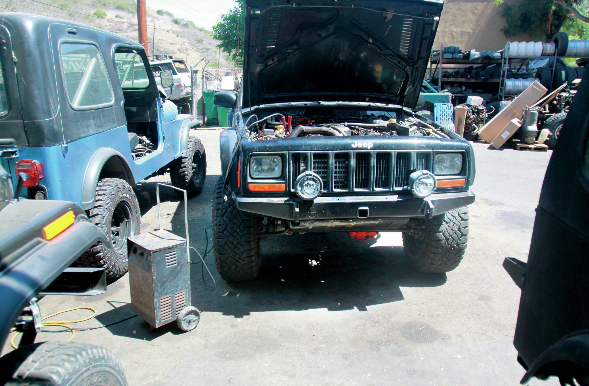 As it turns out, our nearly dead battery wasn’t too happy being hooked up to the shop charger on the high amperage setting. We thought for sure the battery was dead, but we later tested it, and it came out just fine. Once it was charged, the tech decided just to try to swap coils again. The Jeep fired right up. It turns out we had not one, but two bad coils, both of which died from sitting and doing nothing. We still aren’t sure how that is possible.