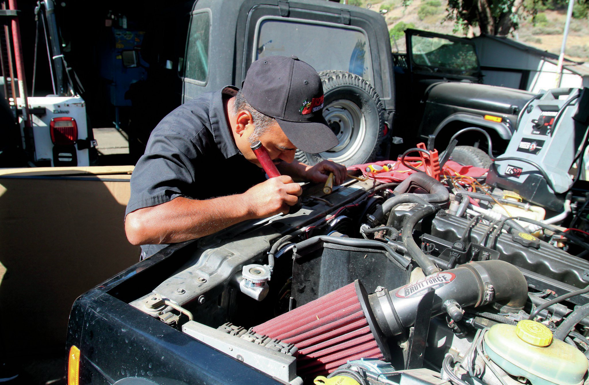 In bright daylight or in shadows, it helps to use a flashlight to verify where the timing marks are. Even though we’d marked the balancer and cleaned the engine-side scale, it still helps.